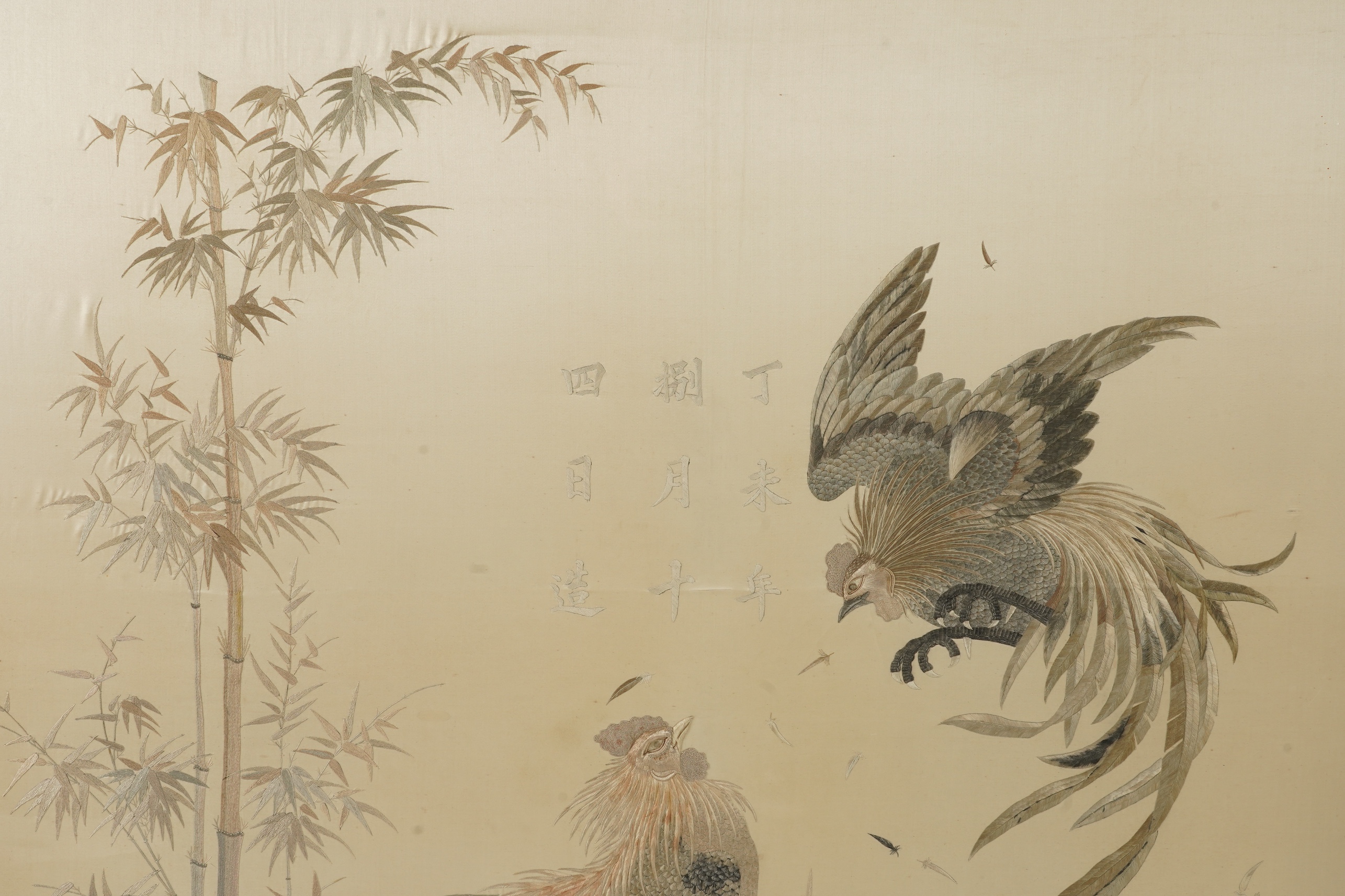 A large Japanese embroidered ‘fighting cockerels’ panel, Meiji period, signed Kawauchi, dated August 14, 1907